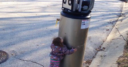 Little girl befriends a robot