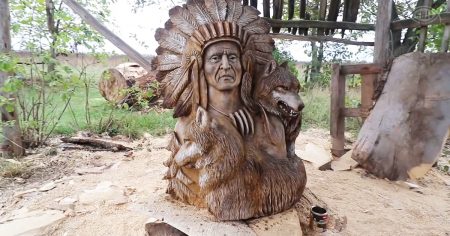 Wood carver uses chainsaw to produce Native American and wolves