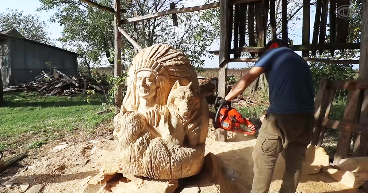 Wood carver uses chainsaw to produce Native American and wolves